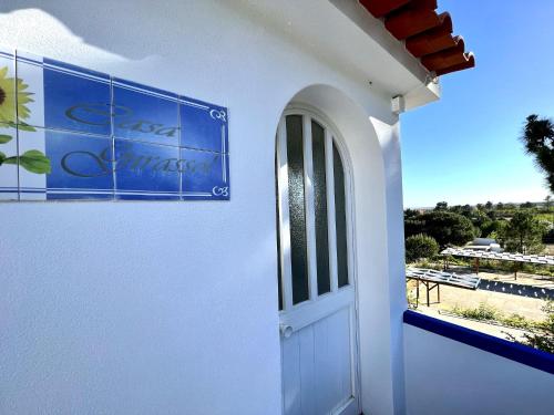 a white house with a door and a window at Tavira Vila Formosa 6 With Pool by Homing in Tavira