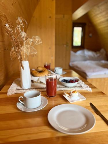 a table with cups and plates of food on it at Gold Camping Seeboden in Seeboden