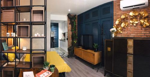 uma sala de estar com televisão e uma parede de tijolos em Sweetheart in Saigon em Ho Chi Minh