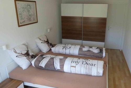 a room with two beds and a mirror at Tgesa Sunnmatt Nr 46 in Savognin