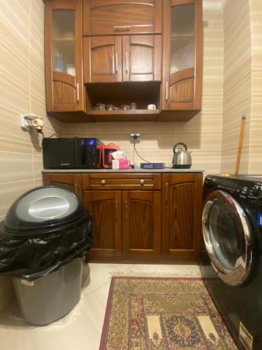 a bathroom with a washing machine and a washer at Relax Inn in New cairo