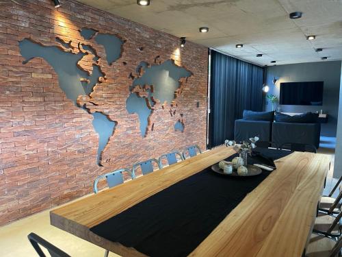 a conference room with a brick wall with a table and chairs at Loft 1930 in Villa Carlos Paz