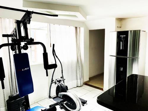 a room with a gym with a exercise bike at The best location in Bogota in Bogotá