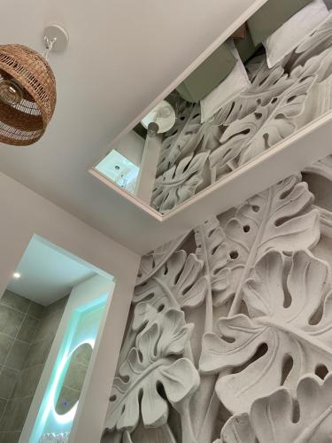 a wall mural in a bathroom with a tree carved into the ceiling at L'extasia appartement,spa jacuzzi Grenoble in Grenoble