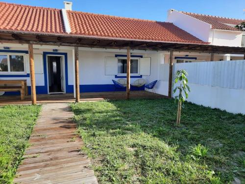 a house with a wooden walkway in front of it at Sado House 2 in Comporta