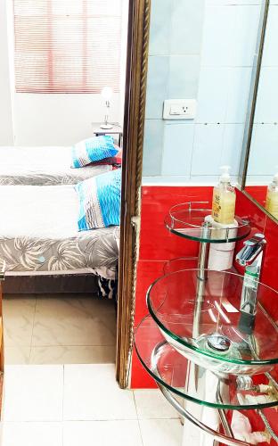 a room with a mirror and a bed and a table at The best location in Bogota in Bogotá
