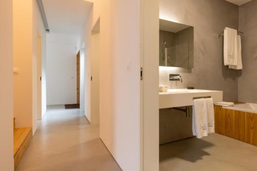 a bathroom with a sink and a mirror at Casa da Rocha by White Exclusive Suites & Villas in Lagoa