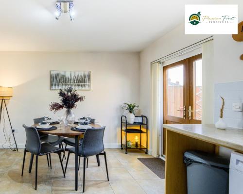 a kitchen and dining room with a table and chairs at Low rate Near Coventry College & Warwickshire Hospital -3 Bedroom house with Ensuite bathroom With free Netflix, Wi-fi, Parking & Garden, - DSC in Coventry
