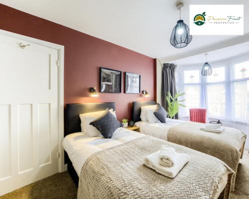 a hotel room with two beds with towels on them at Low rate Near Coventry College & Warwickshire Hospital -3 Bedroom house with Ensuite bathroom With free Netflix, Wi-fi, Parking & Garden, - DSC in Coventry