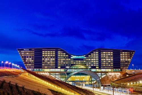 a large building with a bridge in front of it at The Westin Denver International Airport in Denver