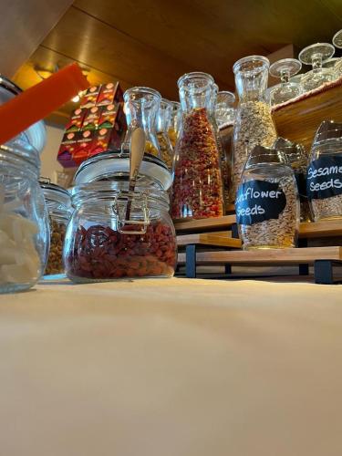 a shelf with jars of beans and other food items at Pension Dolomieu in Santa Cristina in Val Gardena