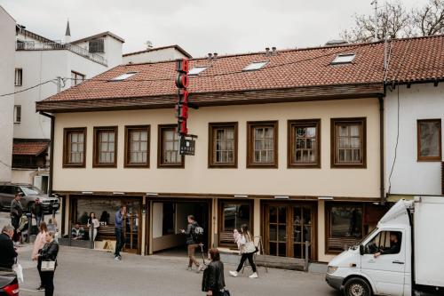 people walking in front of a building with a traffic light at Amber Hotel in Sarajevo