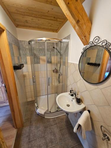 a bathroom with a shower and a sink at Koča na Taležu in Bled