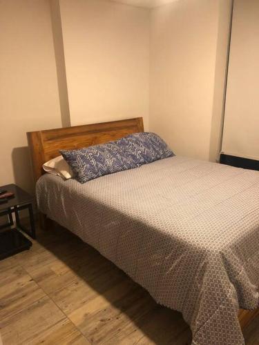 a bedroom with a bed with a pillow on it at precioso apartamento en el norte de armenia contiguo a SAO in Armenia