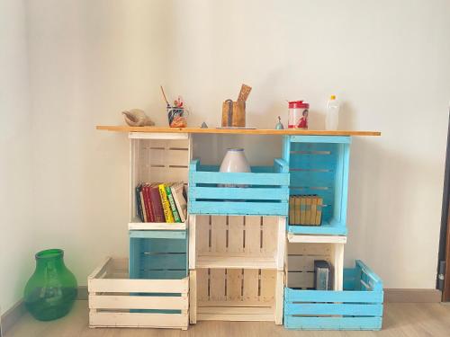 a book shelf with blue and white drawers at "Ciauru i mare" - Pachino in Pachino
