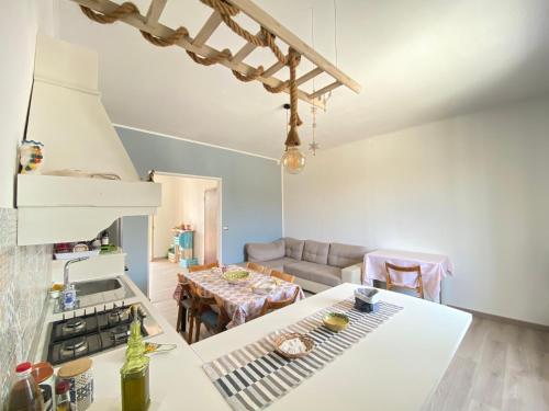 a kitchen and living room with a couch and a table at "Ciauru i mare" - Pachino in Pachino