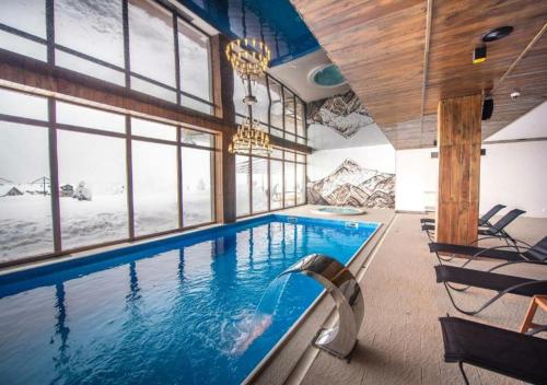 a swimming pool in a house with a mountain view at New Gudauri Suites in Gudauri