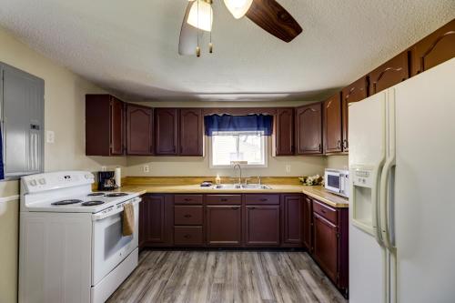 a kitchen with brown cabinets and a white appliance at Pet-Friendly Ohio Escape with Deck and Community Dock! in Celina