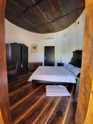 a bedroom with a large bed and wooden floors at Agroturizam Duvančić - Konoba dida Marka in Drniš