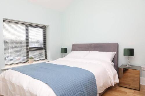 a bedroom with a large bed and a window at Foxford penthouse in Foxford