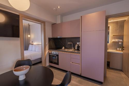 a small room with a kitchen and a bedroom at Aeson Premium Living in Volos