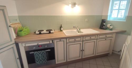 a kitchen with a sink and a counter top at T3 avec sa terrasse au cœur du village médiéval in Sauzet