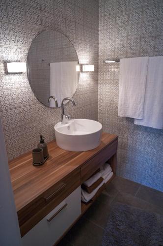 a bathroom with a sink and a mirror and towels at Ferienwohnung Backes in Ettringen