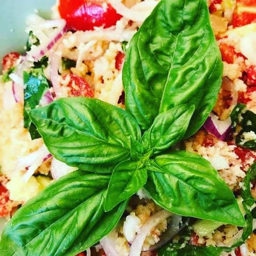 a green basil leaf on top of a pizza at Villa Marinsky Pietrasanta , Lucca in Pietrasanta