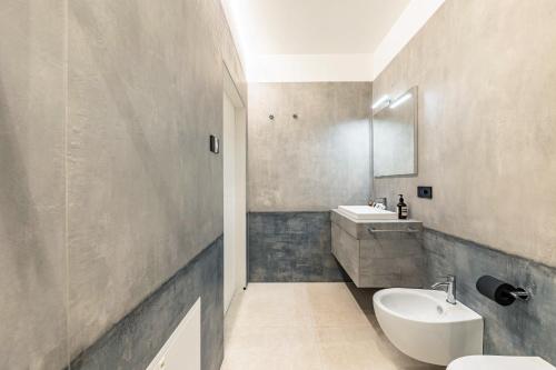 a bathroom with a sink and a white toilet at App 203 Palazzo Cavour in Bolzano