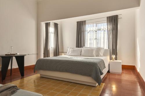 um quarto com uma cama grande e uma janela em Posada Independencia em Oaxaca City