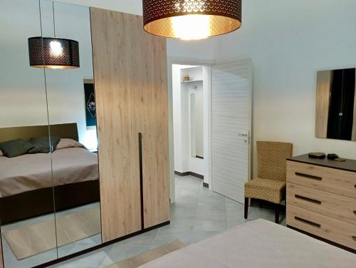 a bedroom with a bed and a dresser and a mirror at A CASA DI GIANNA in Napola