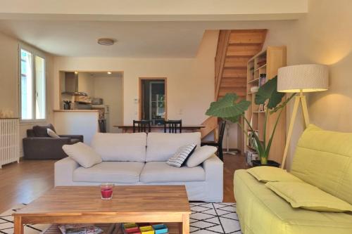 a living room with a couch and a table at Illuminated stall in Chartrons in Bordeaux