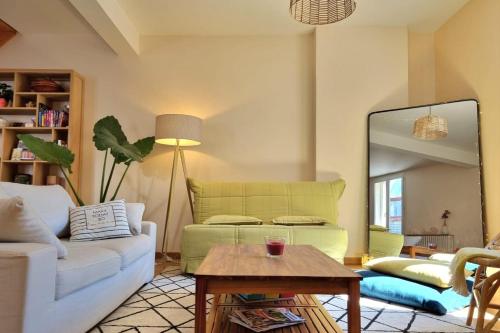 uma sala de estar com um sofá e uma mesa em Illuminated stall in Chartrons em Bordeaux