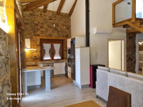 a kitchen with a table and a couch in a room at Casa Grilo in Monforte de Lemos