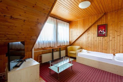 a bedroom with a bed and a tv in a room at Rooms Tereza in Bled