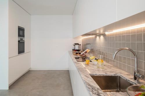 a kitchen with a counter and a sink at CASA DO MIRADOURO 5 by Heart of Funchal in Funchal