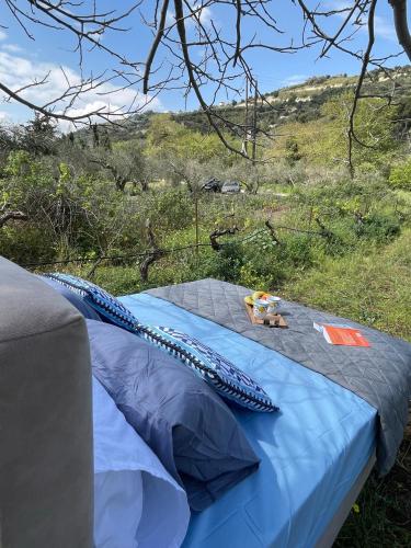 a blue comforter on a bed in a field at Star Sleep Elliniko Heraklio in Heraklio