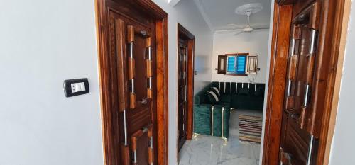 a closet with a wooden door with books in it at La Terrace in Aswan