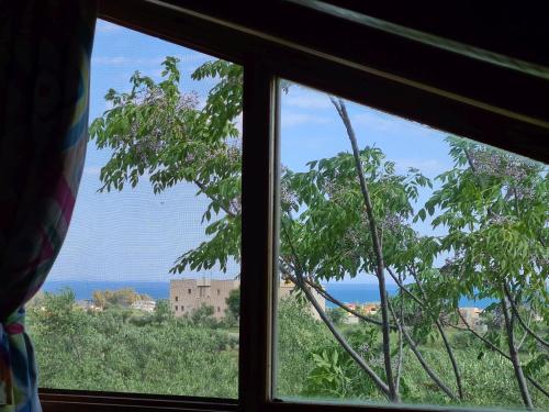 ein Fenster mit Blick auf das Meer durch es hindurch in der Unterkunft Ktirakia Studios in Gythio