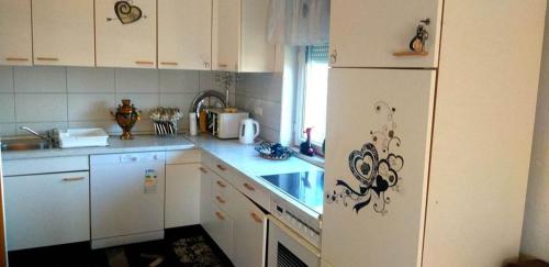 een keuken met witte kasten en een witte koelkast bij Apartmani GS ***** Zavidovici in Zavidovići