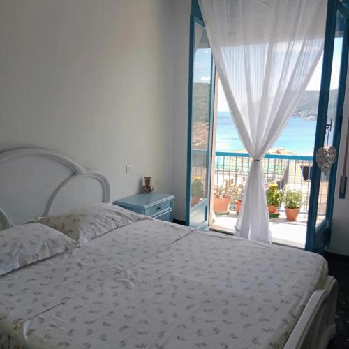 a bedroom with a bed and a view of the ocean at Casa del sole in Spotorno