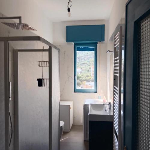 a bathroom with a sink and a toilet and a window at Casa del sole in Spotorno