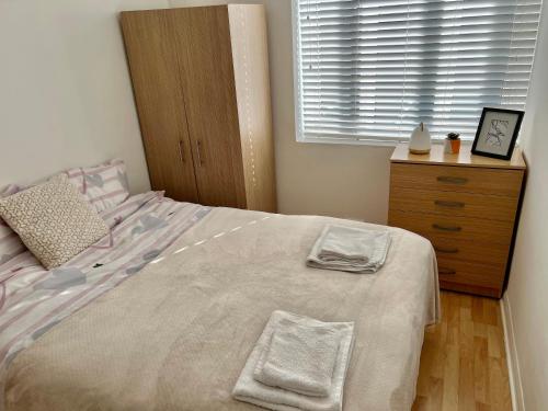 a bedroom with a bed with two towels on it at 2 bedroom near Euston, King's Cross in London