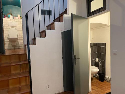 a bathroom with a staircase and a toilet in a room at Maison de village Cévenole climatisée à Branoux-Les-Taillades - Gard - #TravellerAwards 2025 in Branoux-les-Taillades