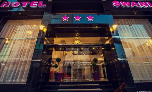 a view of a store front with a neon sign at Hotel Swani in Meknès