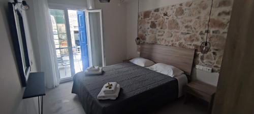 a bedroom with a bed with two towels on it at Studios Iris in Pythagoreio