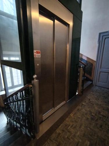 a metal elevator in a building with a door at Loft via morosini centro Varese - IXIHOME in Varese