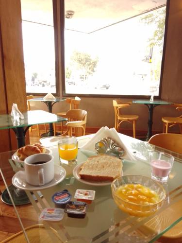 een tafel met een dienblad met ontbijtproducten erop bij HOTEL SANTA CRUZ in Río Gallegos