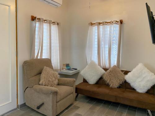 a living room with a couch and a chair at San Pablo Villas in San Pedro