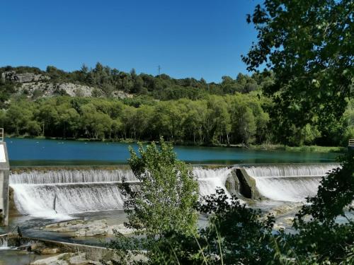een uitzicht op een waterval voor een meer bij Studio in Gréoux-les-Bains